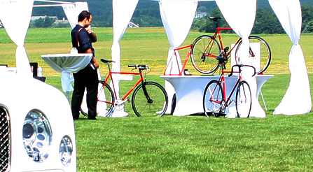 Image demonstrating that Press and fashion photographers study the Italian bicycles.