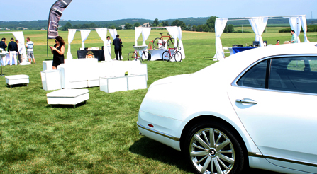 study-of-Iride-Bentley-coach-automobile-comparing-with-Iride-bicycles-velocipede-at-Hamptons-brunch-party-show-iride-bicycles-booth-side-view
